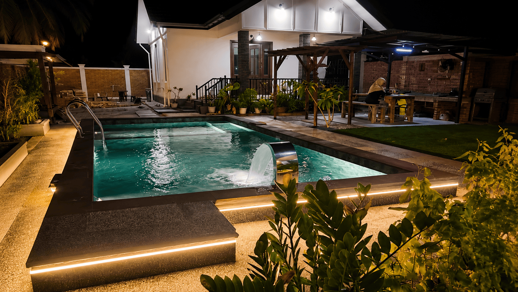 Night pool with pergola and outdoor seating area